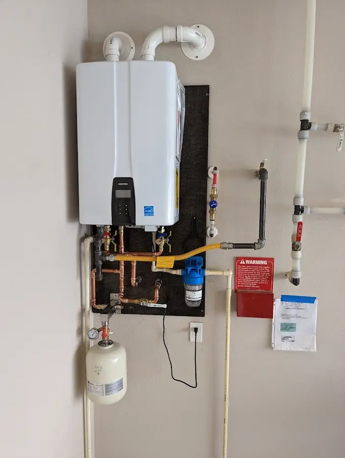 Professional plumber installing copper piping in a Struthers home